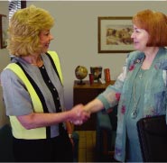 photo of a Job Development Specialist greeting a business woman