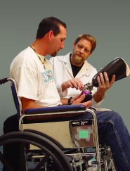 Photo of  young man being fitted with an artificial limb by an Prosthetist-Orthotist